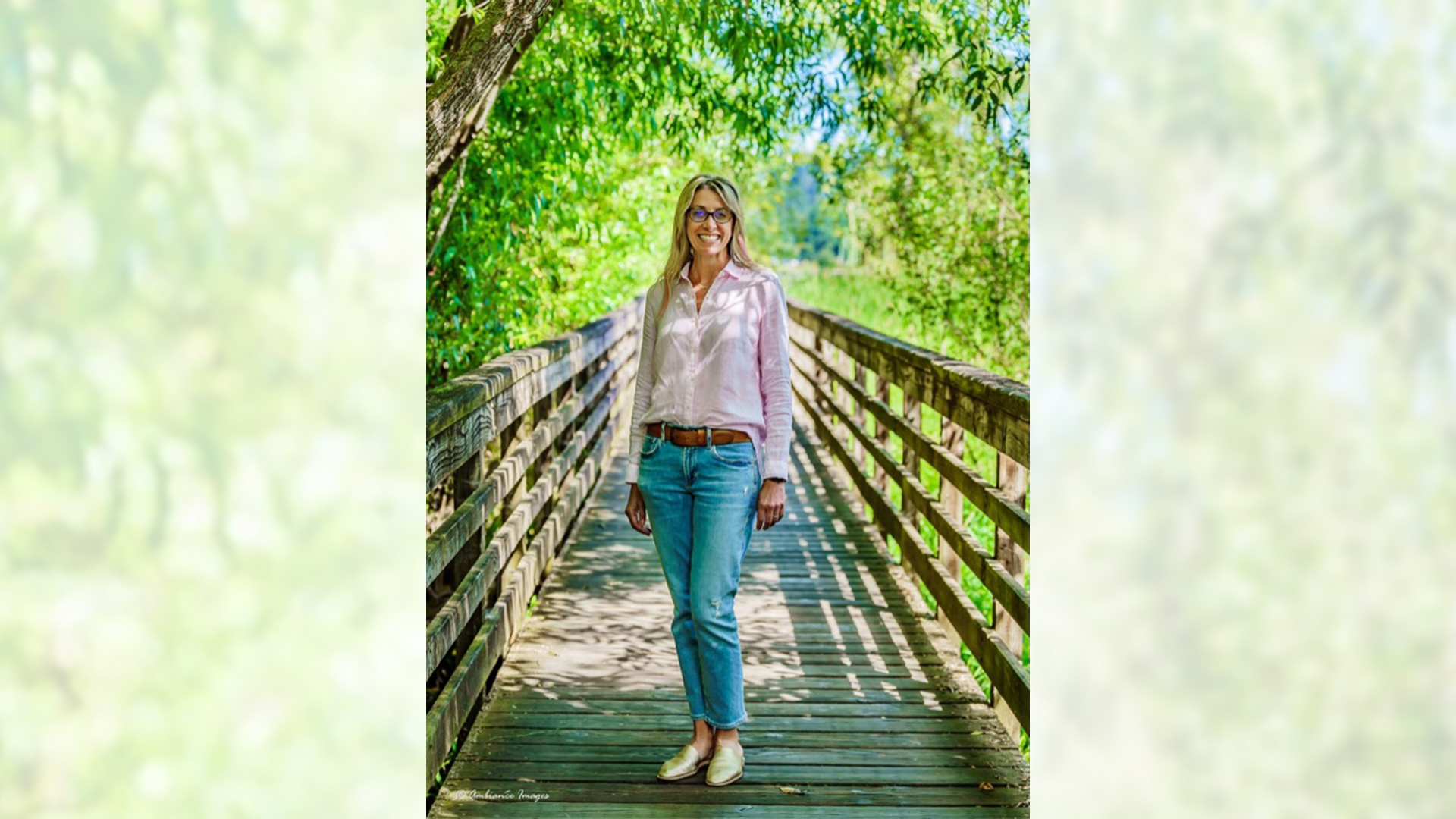 An image of Deb Nielsen, standing on a bridge.